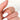 Close-up view of Lenox 14kt Gold Dainty Diamond HALFWAY Eternity Wedding Band on woman's finger, showcasing intricate design and sparkling diamonds