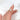 2ct Dakota 2MM 9x7mm 14kt Gold Moissanite Oval Solitaire Ring sparkling in natural light on woman's finger