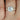 Close-up of the Ready to Ship Antoinette 85mm 14kt Rose Gold Round Forever One Moissanite Diamond Art Deco Vintage Engagement Ring on a white background with intricate vintage detailing and sparkling moissanite diamond