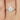 Petite Emery 8x6mm 14kt White Gold Oval Moissanite and Diamond Pear Engagement Ring with delicately crafted detailing and sparkling gemstones
