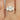 Handcrafted Odessa 9x7mm 14kt Yellow Gold Oval Moissanite Classic 3 Stone Engagement Ring shining in natural light