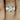 Robyn 7mm 14kt Rose Gold Round Moissanite 3 Stone Bridal Set ring on woman's finger