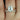 Skinny Lois 10x8mm & Skinny Lima 14kt Rose Gold Oval Moissanite and Diamond Tulip Bridal Set ring on a woman's hand with sunlight shining on it