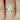 2ct Dakota 9x7mm & Cher 14kt Rose Gold Moissanite Diamond Oval Solitaire Bridal Set displayed on woman's hand with focus on the elegant oval stone and rose gold band