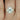 Britney 8x6mm 14kt Yellow Gold Oval Moissanite and Diamonds Halo Engagement Ring with sparkling oval moissanite center stone and diamond halo
