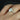 Close-up image of Celeste 8x6mm 14kt White Gold Oval Moissanite and Diamonds Pave Halo Engagement Ring with intricate pave halo design and sparkling moissanite center stone