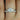 Ella 7mm & Petite Naomi 14kt White Gold Round Moissanite and Diamonds Bridal Set ring on a woman's finger