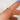 Close-up of a hand wearing a diamond ring with a blurred background