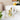 White mug featuring geometric citrine crystal design, displayed on coaster near fresh fruit bowl 