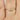 Close-up of 14kt white gold drop leaf tiara curved ring on display 