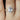 Ready to Ship Rebecca 172cts & Gwen 14kt Rose Gold Icy Silver Blue Sapphire and Diamonds Oval Halo Bridal Set ring displayed on woman's hand with natural light 