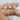 Detailed view of Thelma 10x8mm 14kt White Gold Oval Moissanite and Diamond Twisted Halo Engagement Ring setting and band