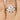 Gold ring with 5 marquise-shaped diamonds fanned next to round solitaire ring