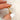 marquise twisted ring pinched by finger on a blurred background
