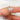 bridal set with a large marquise diamond on a finger against a white background