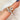 rose cut moissanite oval bezel ring with 5 stone wedding ring on pointer finger