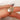 moissanite rose cut oval ring paired with a three diamond celestial curved band in gold on finger