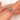 oval cluster ring with cornflower sapphire center stone over pointer finger