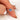 oval cluster ring with cornflower sapphire center stone over pointer facing down white background