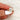 antique cushion button back ring with milgrain edge paired with a open diamond band with pointed opening shown pinched between fingers