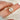 antique cushion button back ring with milgrain edge paired with a open diamond band with pointed opening shown on pointer finger