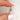 oval cluster ring with cornflower sapphire center stone on pinched finger