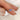 oval cornflower blue sapphire ring in three stone style with two diamonds on 14kt white gold on pointed finger