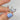 14kt gold ring with blue, black, grey, and pink sapphires in halfway eternity design