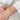 Three sparkling diamonds set in delicate 14kt gold bracelet on a woman's wrist