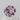 A close-up image of a 055 carat round medium warm peach rose lavender champagne sapphire gemstone